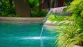 Water flowing water falling into the pond, decoration of the edge of the poo Royalty Free Stock Photo