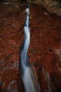 Water flowing through fissure in red rock, Zion National Park, Utah