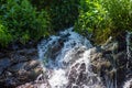 Water flowing in the forest, water splash on a stone Royalty Free Stock Photo