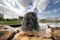 Water flowing out of a rocky fountain in a park Royalty Free Stock Photo