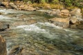 Water flowing over rapid with rocks and boulders Royalty Free Stock Photo