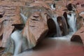 Water flowing over red rock