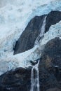 water flowing over rocks at the base of a glacier waterfall Royalty Free Stock Photo