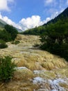 A river flowing over the calcite deposits at Huanglong Scenic Area, China Royalty Free Stock Photo