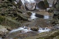 Water flowing over stones. By base of waterfall. Royalty Free Stock Photo