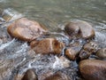 Water flowing over stones Boulders washed by river fluid Amazing water-cascade over natural rocks