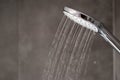 Water flowing from shower, close up. Modern bathroom interior. Chrome shower head with splashing water Royalty Free Stock Photo