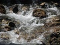 Water flowing and splashing over rocks in a mountain river stream Royalty Free Stock Photo