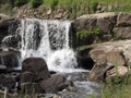 Water flowing and splashing over rocks in a mountain river stream Royalty Free Stock Photo