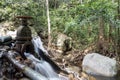 The water flowing from the steel drain into the brook of the waterfall in the tropical forest Royalty Free Stock Photo