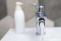 water flowing from a tap in a home bathroom. bathroom supplies with flowing water and blurred background Royalty Free Stock Photo