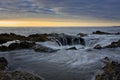 Water flowing into Thor`s Well during dramatic sunset Cape Perpetua Oregon