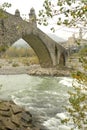 Water flowing under the old stone bridge