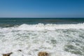 Water flowing and waves in the Mediterranean sea and blue sky at the Tel Aviv port, Israel Royalty Free Stock Photo