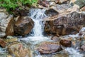 Water flows down huge stones. A real natural waterfall in the mountains Royalty Free Stock Photo