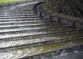 Water flows down the stone steps of the stairs Royalty Free Stock Photo