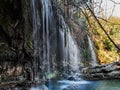 Water flows downstream from the waterfall from the mountains.