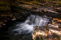 Water flows gently over rocks in Fall Royalty Free Stock Photo