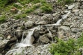 Water flows over rocks with mountain waterfall. Beautiful mountain river Royalty Free Stock Photo