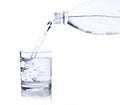 Water, flows from a plastic bottle in a glass Royalty Free Stock Photo