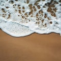 Water foam with smooth sand waves on tropical beach photo Royalty Free Stock Photo