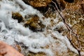 Water foaming from rushing over rocks at a water fall Royalty Free Stock Photo