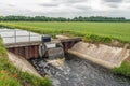 Overflowing weir in a Dutch polder landscape Royalty Free Stock Photo