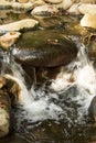 Water in the form of a waterfall between stones Royalty Free Stock Photo