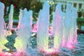 Water fountain and colored lights at night Royalty Free Stock Photo