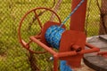 Water fountain crank with blue rope. Metal crank on a rustic fountain.