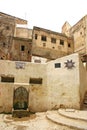 Water fountain, houses and street signs in the ancient medina of