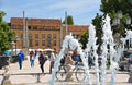 Water fountain, people, colorful buildings, architecture, green park and old facade with blue sky in Padua Veneto, italy Royalty Free Stock Photo