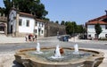 Water fountain in the Republic of Brazil Square, section of medieval city wall in the background, Guimaraes, Portugal