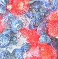 Water with fresh berries, close-up. Close-up view of the blueberries and raspberries in water background. Texture of Royalty Free Stock Photo