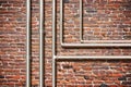 Water and gas pipeline in front of an old brick wall Royalty Free Stock Photo