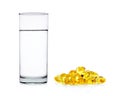 Water of glass with fish oil capsules isolated on the white back Royalty Free Stock Photo