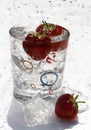 Water glass ice cube and strawberries Royalty Free Stock Photo
