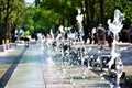 Water gushing from the fountain in the middle of the sidewalk