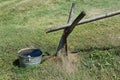 Water from a hand pump runs down a pipe into a collection pail Royalty Free Stock Photo