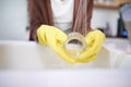 Water, hands and gloves for cleaning glass, dirty dishes and person with house work for hygiene and routine. Tap, sink Royalty Free Stock Photo