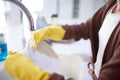 Water, hands and gloves for cleaning plate, dirty dishes and person with house work for hygiene and routine. Tap, sink Royalty Free Stock Photo