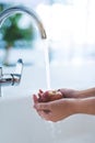 Water, hands and person wash apple, hygiene in kitchen with sustainability and disinfection, germs or bacteria. Health Royalty Free Stock Photo