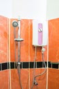 Water heater and shower in brown bathroom Royalty Free Stock Photo