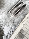 Water from heavy rain flows into a sewer drain Royalty Free Stock Photo