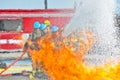 Water hitting fire with firemen Royalty Free Stock Photo