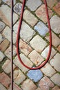 Water hose on a cobble stone floor Royalty Free Stock Photo