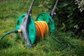 Water hose on grass outside Royalty Free Stock Photo