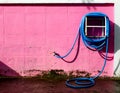 Water hose winder wall pink. After the analysis is completed Royalty Free Stock Photo