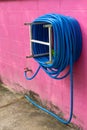 Water hose winder wall pink. Royalty Free Stock Photo
