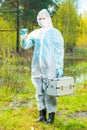 water intake for research in the laboratory, environmentalist in protective clothing at a water source